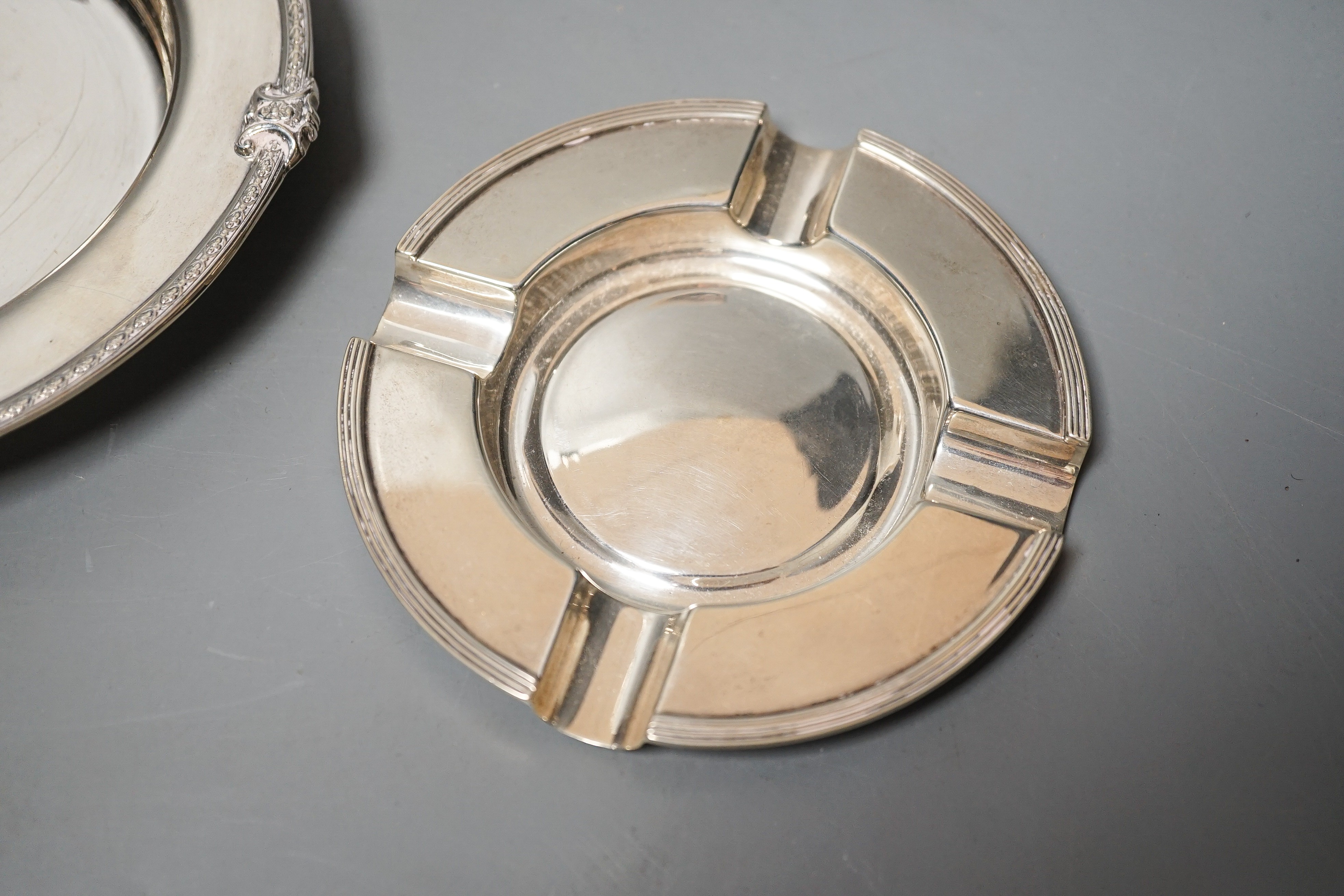 A George V silver shallow dish or stand, Adie Bros. Birmingham, 1927, 16.2cm and a silver ashtray, 11oz.